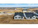 Aerial view of a home in a new development featuring a beautiful lake view at 17196 W 92Nd Loop, Arvada, CO 80007