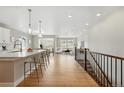 Open floor plan showing kitchen and living area filled with natural light and modern décor at 17196 W 92Nd Loop, Arvada, CO 80007