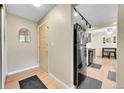 Entryway view with black appliances and hardwood floors at 4066 S Atchison Way # 102, Aurora, CO 80014