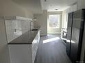 Modern kitchen with white cabinetry, subway tile backsplash, and stainless steel appliances at 1642 N Lafayette St # 2, Denver, CO 80218
