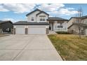 Inviting two-story home with a covered porch, well-maintained lawn, and a convenient two-car garage at 5826 Sunburst Ave, Firestone, CO 80504