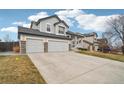 Traditional two-story home with a two-car garage, covered porch, and a well-manicured front yard at 5826 Sunburst Ave, Firestone, CO 80504