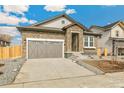 Charming home featuring stone accents, a two-car garage, and a well-maintained driveway at 6187 E 155Th Pl, Thornton, CO 80602