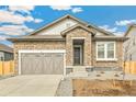 Charming home featuring stone accents, a two-car garage, and a well-maintained driveway at 6187 E 155Th Pl, Thornton, CO 80602