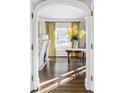 Sun-drenched entryway with hardwood floors and an elegant round table at 140 Race St, Denver, CO 80206