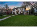 Charming two-story home with a lush green lawn at 140 Race St, Denver, CO 80206