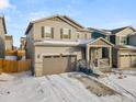 Two-story house with gray siding, stone accents, and a two-car garage at 656 N Bersshine St, Watkins, CO 80137