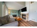 Comfortable living room featuring a fireplace, built-in shelving, piano, and hardwood floors at 4720 S Dudley St # 44, Littleton, CO 80123