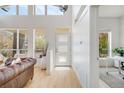 Bright foyer with soaring ceilings, hardwood floors, large windows, and a modern three panel front door at 2777 Ironton St, Denver, CO 80238