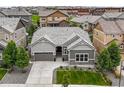 Charming single-Gathering home features neutral toned exterior, landscaped yard, and a convenient two-car attached garage at 16256 Ute Peak Way, Broomfield, CO 80023