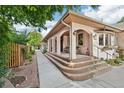 Charming front porch featuring arched columns and a welcoming entrance to the home at 2069 Garrison St, Lakewood, CO 80215