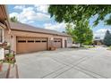 Attached three-car garage with ample driveway space, providing convenience and extra parking at 2069 Garrison St, Lakewood, CO 80215