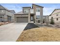 Beautiful two-story home with a modern design, stone accents, well-kept lawn, and a two car garage at 8290 Superior Cir, Littleton, CO 80125