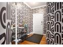 Stylish entryway with bold wallpaper, modern console table, and wood flooring at 111 S Monroe St # B104, Denver, CO 80209