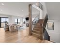 Elegant staircase with wooden steps, black metal railings, and an open floor plan leading to the living area at 15322 Irving Ct, Broomfield, CO 80023