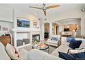 Bright living room with fireplace, mantle-mounted television and plush seating, and light colored furniture at 1767 N Pearl St # 308, Denver, CO 80203