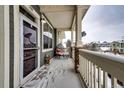 Small front porch with seating area, covered and with snowy ground at 9381 Ashbury Cir # 102, Parker, CO 80134