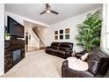 Spacious living room with a fireplace and leather furniture at 9381 Ashbury Cir # 102, Parker, CO 80134