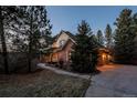 Charming two-story home with brick and siding exterior, large trees and walkway, showcasing curb appeal at 870 Homestake Ct, Castle Rock, CO 80108