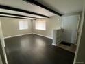 Spacious living room featuring hardwood floors, exposed beams, and bright windows at 217 Ford St, Golden, CO 80403