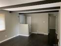 Bright living room showcasing hardwood floors, exposed beams, and a neutral color palette at 217 Ford St, Golden, CO 80403