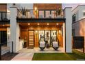 Welcoming front porch with decorative hanging chairs and modern wood-and-glass door at 340 Milwaukee St, Denver, CO 80206