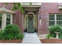 Close-up of the charming brick home showcasing the front door and well-maintained landscaping at 9165 Kornbrust Dr, Lone Tree, CO 80124