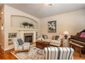 Inviting living room featuring a fireplace, built-in shelving, and stylish furnishings at 9165 Kornbrust Dr, Lone Tree, CO 80124