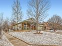 Charming single Gathering home with covered porch, American flag, and a well-maintained lawn at 23236 Chapel Hill Pl, Parker, CO 80138