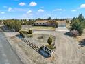 A beautiful aerial view of the property, featuring well-maintained landscaping and a circular driveway at 40154 E Colorado Ave, Bennett, CO 80102