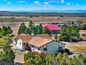An aerial view of the home and its surroundings, showcasing the home's rural setting at 40154 E Colorado Ave, Bennett, CO 80102
