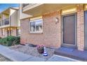 Charming entrance to townhome with brick facade, decorative plants, and welcoming walkway at 750 Tabor St # 46, Lakewood, CO 80401
