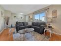 Inviting living room with plush gray sectional, light-filled window, and stylish decor at 750 Tabor St # 46, Lakewood, CO 80401