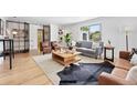Inviting living room with hardwood floors, comfortable seating, and ample natural light from a window at 2675 S Eudora St, Denver, CO 80222
