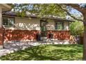 Beautiful home exterior with brick accents, well manicured lawn and front entryway at 6470 Field St, Arvada, CO 80004
