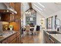 Bright open floor plan with seamless flow from kitchen to dining and living areas, featuring a cozy fireplace at 9703 Phillips Rd, Lafayette, CO 80026