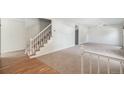 Bright living room featuring neutral carpet, stairway, and open layout at 15892 E Arkansas Pl, Aurora, CO 80017