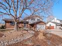 Charming two-story home with brick and siding exterior, landscaping, and a two car garage at 2165 S Flower St, Lakewood, CO 80227