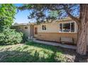 Inviting home exterior with brick accents, garden space, and manicured lawn at 6780 Allison St, Arvada, CO 80004