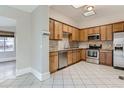 Well-lit kitchen with stainless steel appliances, granite countertops, and tiled backsplash at 1839 Grove St, Denver, CO 80204