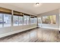 Sunroom features wood-look floors and wall-to-wall windows at 1839 Grove St, Denver, CO 80204