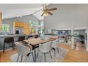 Open-concept dining area with vaulted ceilings, modern chandelier, and hardwood floors at 19937 E Loyola Pl, Aurora, CO 80013