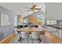 Bright dining area features hardwood floors, vaulted ceilings and views to the kitchen and living area at 19937 E Loyola Pl, Aurora, CO 80013