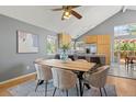 Comfortable dining area featuring wood floors, vaulted ceilings and views to the kitchen at 19937 E Loyola Pl, Aurora, CO 80013