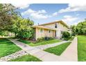Charming home exterior with lush lawn, rock details, and inviting curb appeal at 1250 S Monaco Pkwy # 67, Denver, CO 80224
