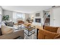 Cozy living room with a fireplace, comfortable seating, and staircase at 2930 S Birch St, Denver, CO 80222