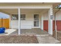 Inviting covered front porch with a secure screen door and convenient house number display at 1277 Wabash St, Denver, CO 80220