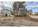 Charming single story home with a well manicured lawn and a large tree, fenced in yard at 1277 Wabash St, Denver, CO 80220