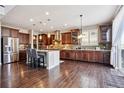 Spacious kitchen featuring stainless steel appliances, ample counter space, and dark wood cabinetry at 3493 Princeton Pl, Broomfield, CO 80023