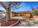 Inviting brick home with a welcoming stone-paved entrance and well-maintained facade at 14091 W Exposition Dr, Lakewood, CO 80228